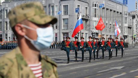 A Russian soldier wears a face mask in Lenin Square during the parade.