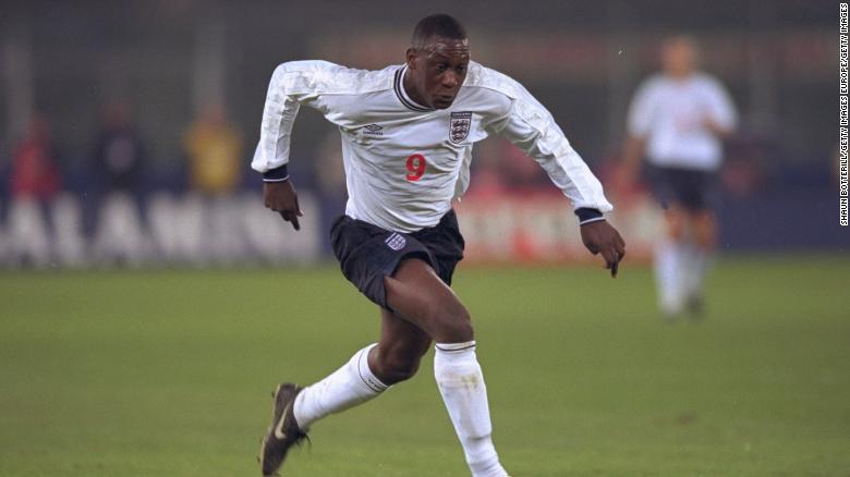 Heskey is pictured playing for England against Italy.