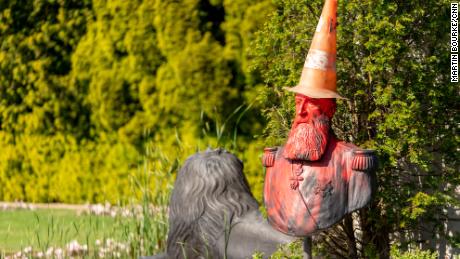 A statue in the grounds of Belgium&#39;s Royal Museum for Central Africa, featuring a bust of King Leopold II, was covered in red paint and topped with a traffic cone &quot;dunce&#39;s cap.&quot;
