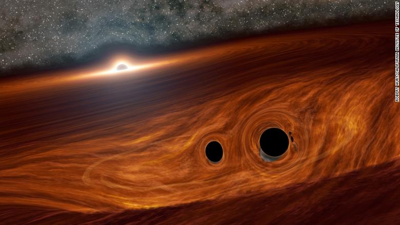 This is an artist&#39;s illustration of a supermassive black hole and its surrounding disk of gas. Inside this disk are two smaller black holes orbiting one another. Researchers identified a flare of light suspected to have come from one such binary pair soon after they merged into a larger black hole. 