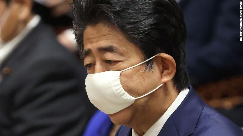 Japan&#39;s Prime Minister Shinzo Abe wearing a face mask amid concerns over the spread of coronavirus speaks during a budget committee session in the lower house at parliament in Tokyo on June 10, 2020.