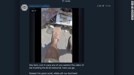 A man is seen &quot;trashing&quot; a Black Lives Matter memorial in a screengrab from a video shared on one of more than 200 White supremacist Telegram groups that have become much more active during protests across the United States. CNN has obscured identifying information in this image.