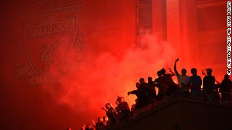 Fans outside Anfield, celebrating Liverpool's historic win. 