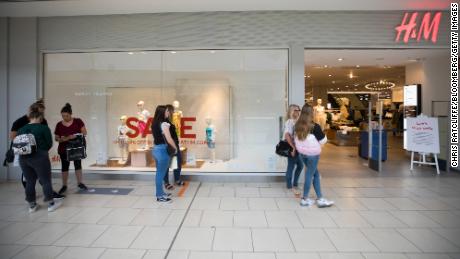 Shoppers queue at an H&amp;M store at the Lakeside shopping centre, operated by Intu, in Thurrock, UK, on June 19.