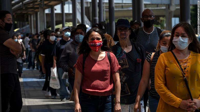 Commuters line up to cross to the United States at the San Ysidro crossing port in Tijuana on June 16, 2020.