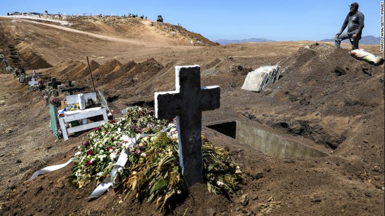 A cemetery worker takes a break from digging new graves at Tijuana Municipal Cemetery 13 amid the COVID-19 pandemic on May 11, 2020 in Tijuana, Mexico. 