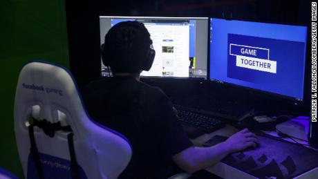 An attendee plays a game at the Facebook Inc. Gaming booth during the E3 Electronic Entertainment Expo in Los Angeles, California, U.S., on Wednesday, June 12, 2019. For three days, leading-edge companies, groundbreaking new technologies and never-before-seen products are showcased at E3. Photographer: Patrick T. Fallon/Bloomberg via Getty Images