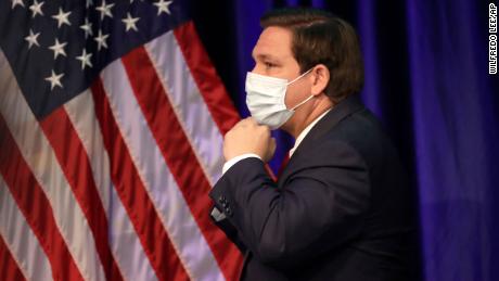 Florida governor and staunch Trump ally Ron DeSantis has resisted mandating masks for all, but he did don his own mask as he left a news conference on June 19 at Florida International University in Miami.