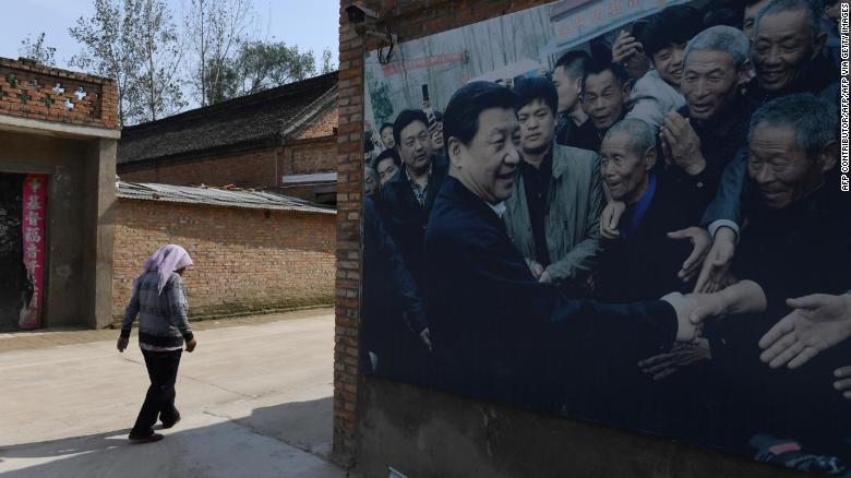 This photo taken in September 2017 shows A billboard featuring a photo of China&#39;s President Xi Jinping visiting residents in Zhangzhuang village in Lankao in China&#39;s central Henan province. 