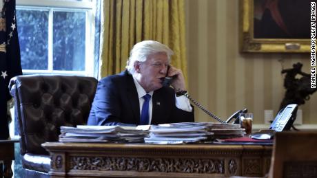 Trump speaks on the phone with Russia&#39;s President Vladimir Putin from the Oval Office of the White House in January 2017.
