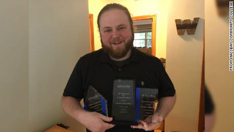 Ward with the awards he received at the commencement ceremony for his 4.0 GPA. 