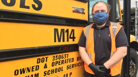 Ward in front of the school bus he drove while students were still going to school before the Covid-19 pandemic. 