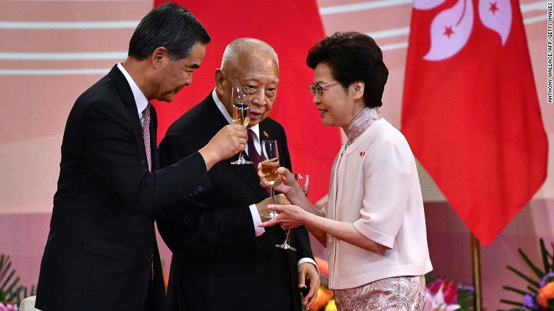 Hong Kong&#39;s Chief Executive Carrie Lam (right) makes a toast with former leaders Tung Chee-hwa (center) and Leung Chun-ying (left) following a ceremony to mark the 23rd anniversary of Hong Kong&#39;s handover on July 1, 2020.