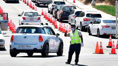 Traffic is directed at Dodger Stadium as people arrive for coronavirus testing in Los Angeles. 