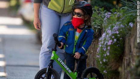 A 3-year-old wraps up a bike ride on Randolph Place NW, in the Bloomingdale neighborhood during the coronavirus outbreak on Monday, April 6, 2020.