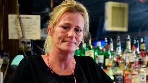 Owner of Big Daddy Zane's Gabrielle Ellison poses for a photo behind the bar top of her establishment in Odessa, Texas, Friday, June 26, 2020. Ellison was operating her bar in violation of Texas Gov. Greg Abbott's new order that shut bars back down and limits restaurants' capacities to 50% following a surge in coronavirus cases. (Eli Hartman/Odessa American via AP)