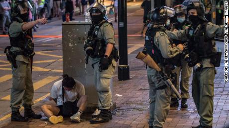 Riot police detain a man after they cleared protesters taking part in a rally against a new national security law in Hong Kong on July 1, 2020.