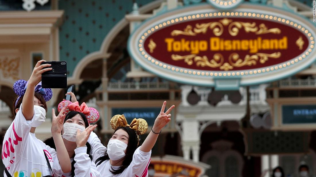 Visitors take a selfie at the entrance gate of Tokyo Disneyland on July 1. &lt;a href=&quot;https://www.cnn.com/travel/article/tokyo-disneyland-reopening-coronavirus-intl-hnk/index.html?search&quot; target=&quot;_blank&quot;&gt;Tokyo Disneyland&lt;/a&gt; and Tokyo Disney Sea are reopening after months of being closed because of the pandemic. All of Disney&#39;s Asia parks have now officially reopened.