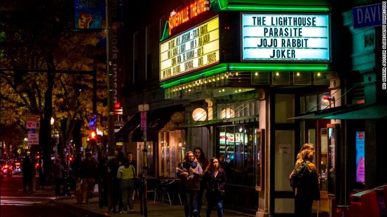 People walk past the Somerville Theatre in Somerville, Massachusetts on November 7, 2019. The city has now adopted a domestic partnership ordinance recognizing polyamorous relationships.