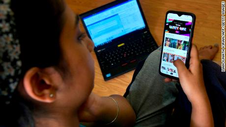 An Indian mobile user browses through the Chinese owned video-sharing &#39;Tik Tok&#39; app on a smartphone in Bangalore on June 30, 2020.  TikTok on June 30 denied sharing information on Indian users with the Chinese government, after New Delhi banned the wildly popular app citing national security and privacy concerns. &quot;TikTok continues to comply with all data privacy and security requirements under Indian law and have not shared any information of our users in India with any foreign government, including the Chinese Government,&quot; said the company, which is owned by China&#39;s ByteDance. (Photo by Manjunath Kiran / AFP) (Photo by MANJUNATH KIRAN/AFP via Getty Images)
