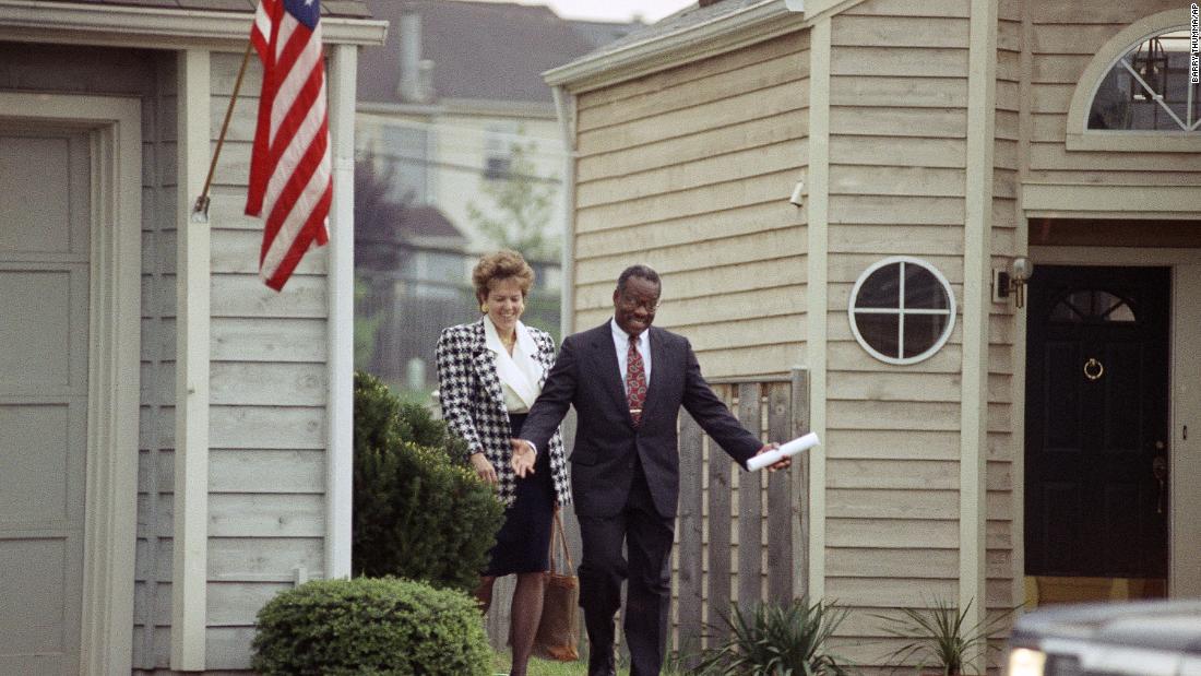 Thomas leaves his Alexandria, Virginia, home with his wife in October 1991.