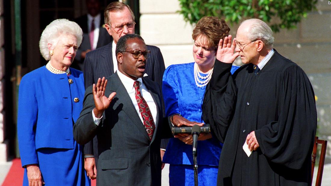 Thomas is sworn in to the Supreme Court by Justice Byron White. Joining him is his wife, the President and first lady Barbara Bush.