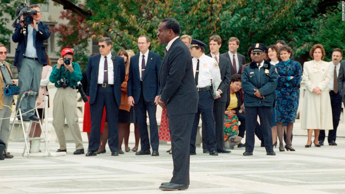 Thomas talks to reporters outside the Supreme Court in November 1991.