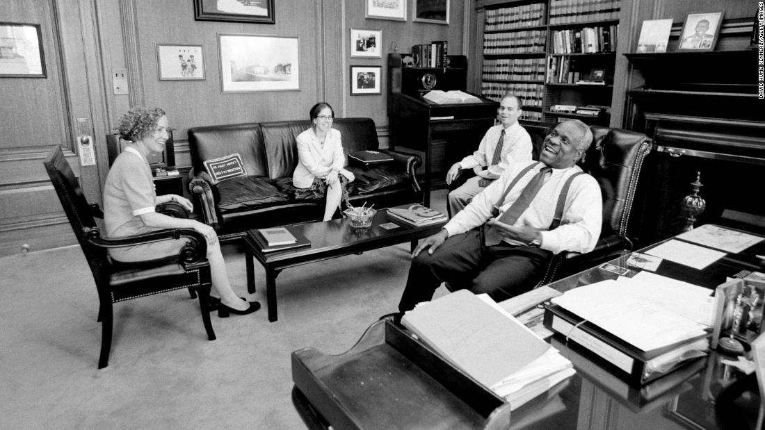 Thomas sits in his chambers with three of his clerks in 2002.