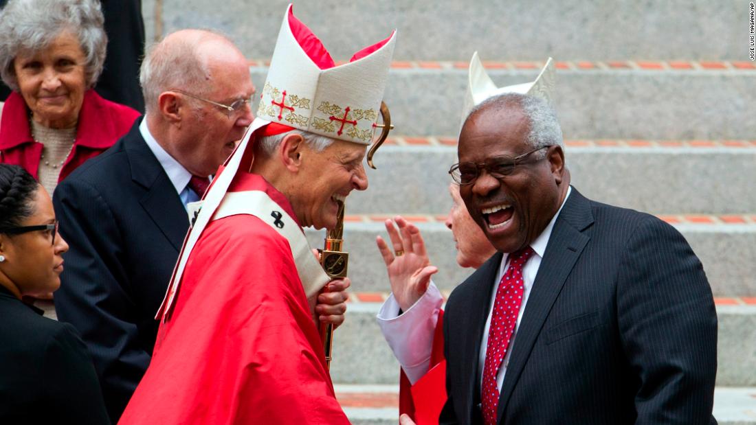 Cardinal Donald Wuerl, the archbishop of Washington, DC, shakes hands with Thomas in 2015.
