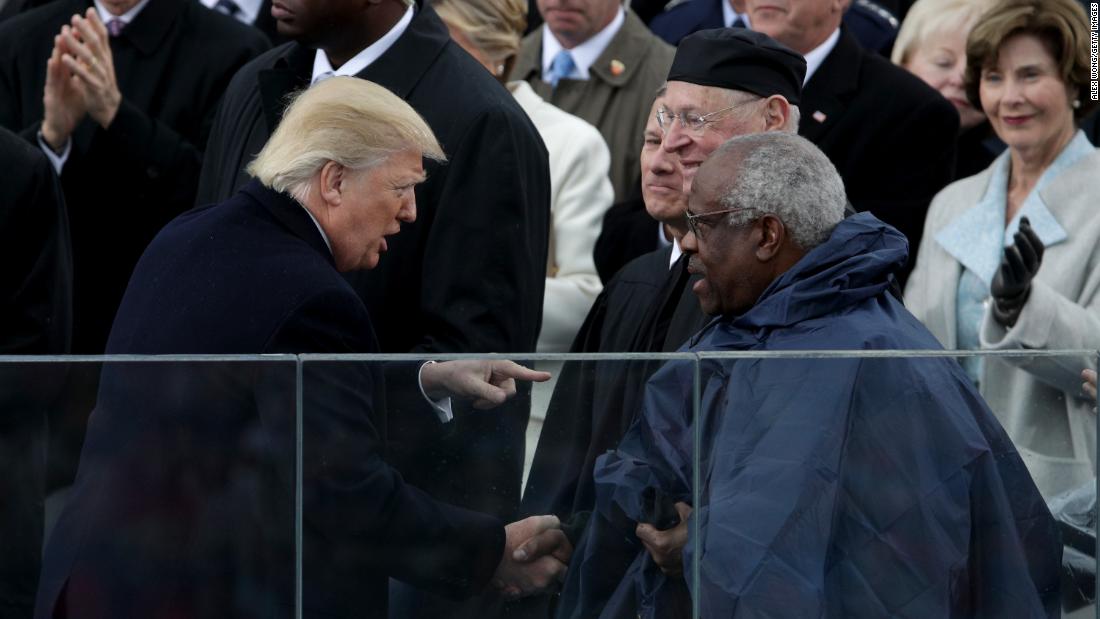 President Donald Trump shakes Thomas' hand at his inauguration in 2017.