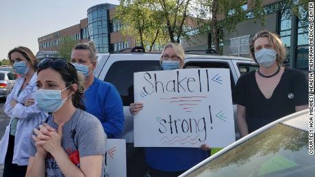 Healthcare workers celebrate Shakell Avery's recovery outside Menorah Medical Center on June 30.