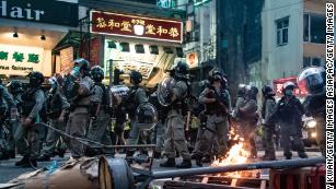Riot police are seen in front of a burning road block during a protest against the new national security law on July 1, 2020, in Hong Kong. 