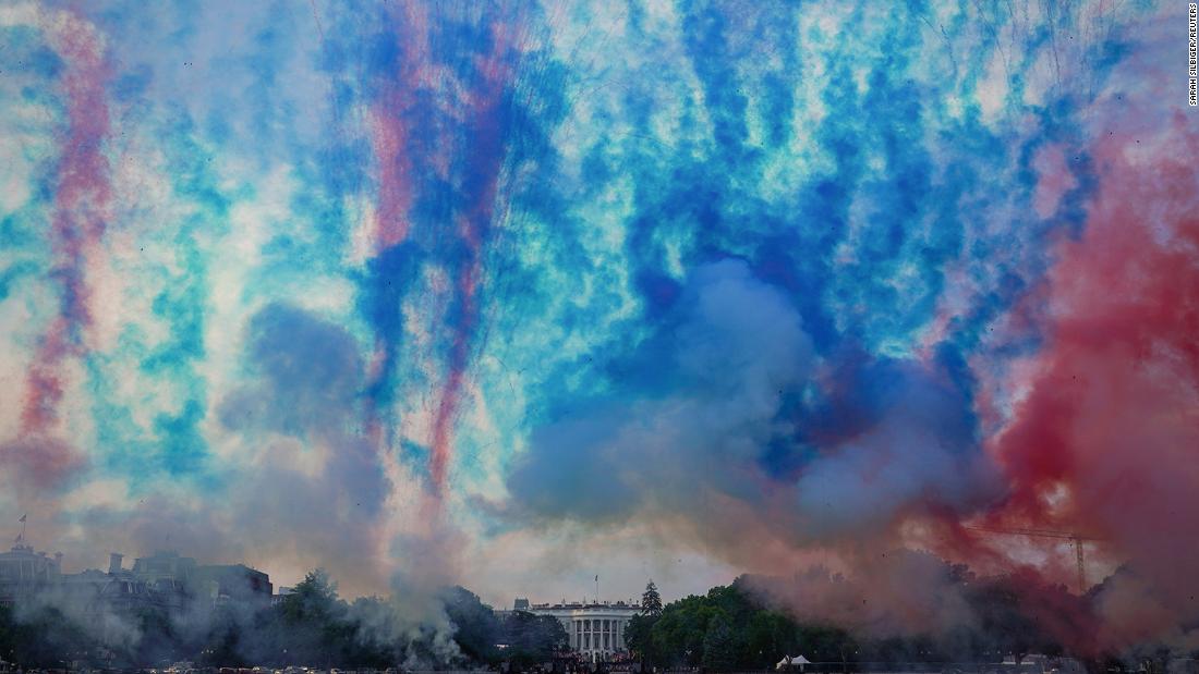 Red and blue smoke is fired during the &quot;Salute to America&quot; event near the White House in Washington DC. 