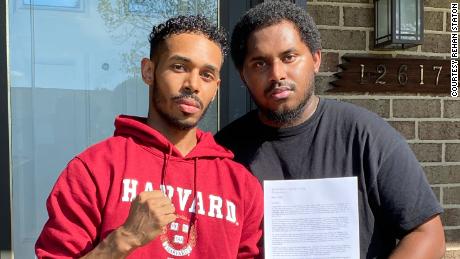 Rehan Staton, 24, with his brother Reggie Staton, 27, holding his acceptance letter to Harvard Law School. 