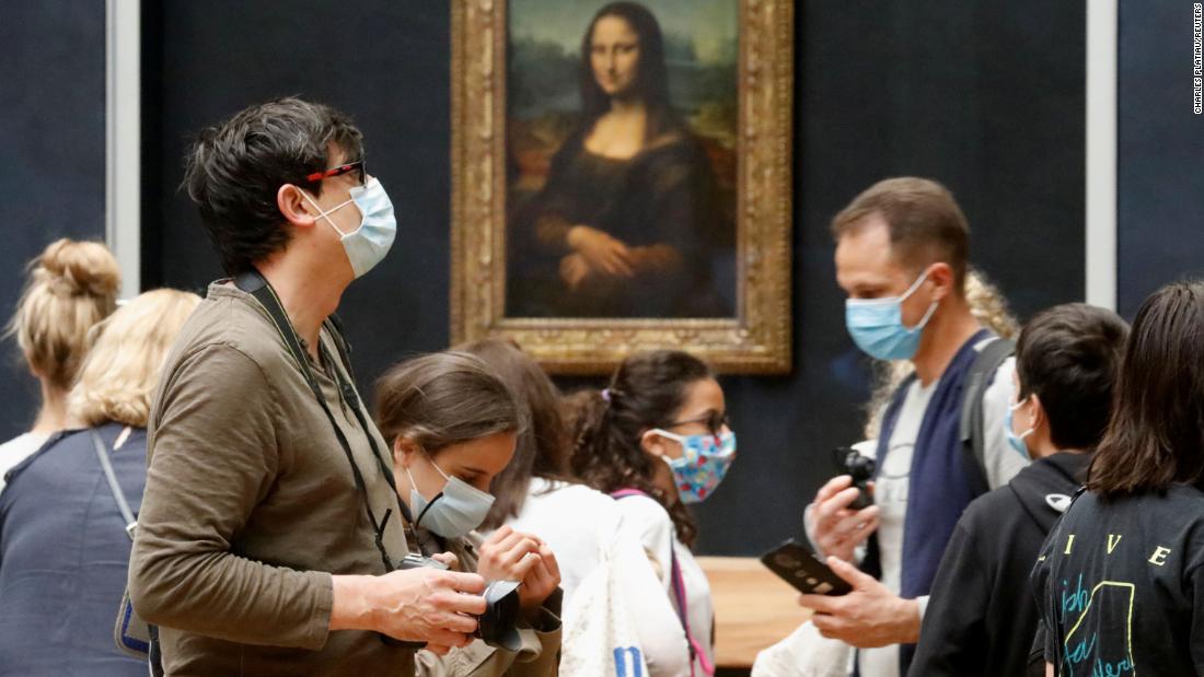 Visitors stand in front of the &quot;Mona Lisa&quot; at the Louvre in Paris on July 6. The Louvre, the world&#39;s most popular museum, &lt;a href=&quot;https://www.cnn.com/travel/article/louvre-reopens-july/index.html&quot; target=&quot;_blank&quot;&gt;has reopened its doors&lt;/a&gt; after months of closure.