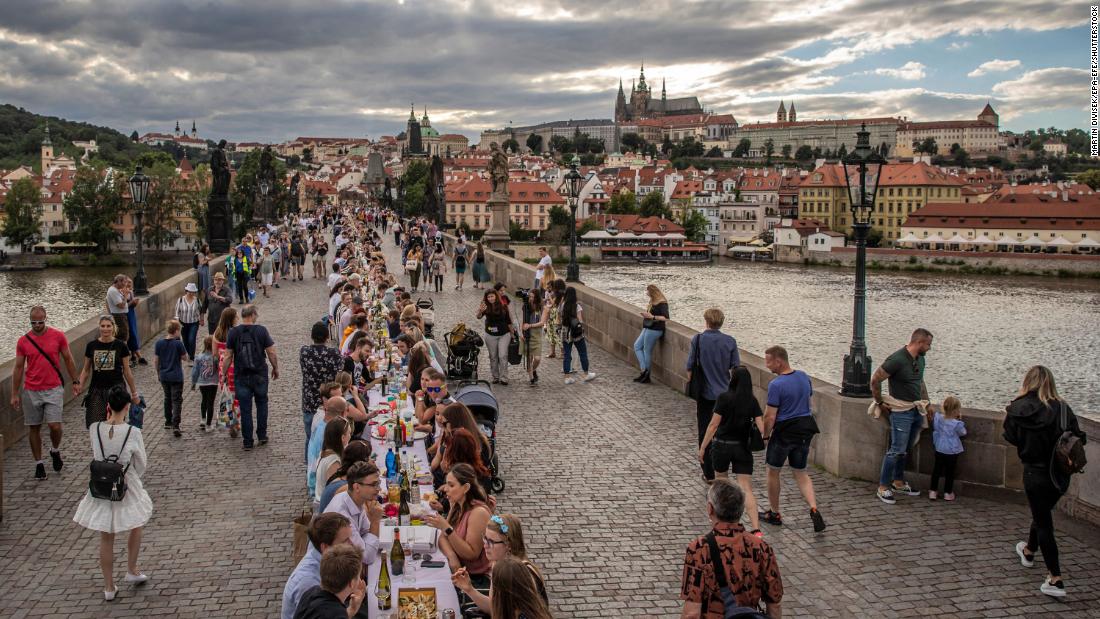 People sit at a giant table on the Charles Bridge in Prague, Czech Republic, on June 30. To celebrate the end of the country&#39;s lockdown, cafe owner Ondrej Kobza organized &lt;a href=&quot;https://www.cnn.com/travel/article/czech-public-dinner-lockdown-scli-intl/index.html&quot; target=&quot;_blank&quot;&gt;the dinner party.&lt;/a&gt; &quot;We want to celebrate the end of the coronavirus crisis with people meeting up and showing they&#39;re no longer afraid to meet others. That they aren&#39;t afraid to accept a bite of a sandwich from someone,&quot; Kobza told the Agence France-Presse news agency. The Czech Republic was quick to implement a lockdown at the start of the outbreak and became one of the first countries to tell its citizens to wear masks. That helped it avoid the worst of the pandemic and ease restrictions earlier than many other nations.