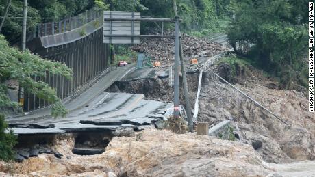 A road is destroyed following torrential rain near the Kuma river in Ashikita, Kumamoto prefecture, on July 6, 2020. 