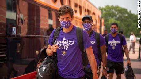Players from Orlando City exit the team bus ahead of training.