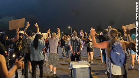 Protesters walk along Encanto Boulevard on July 5 after Phoenix police shot and killed a man the previous day.