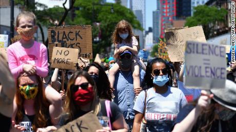 Families participate in a children&#39;s march in solidarity with the Black Lives Matter movement and national protests against police brutality June 9, 2020, in Brooklyn, New York.