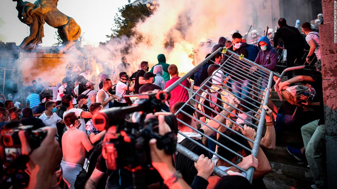 Protesters clash with police in front of Serbia&#39;s National Assembly building in Belgrade on July 8. &lt;a href=&quot;http://edition.cnn.com/world/live-news/coronavirus-pandemic-07-08-20-intl/h_570a4c52facd841fd36b61439b06ef63&quot; target=&quot;_blank&quot;&gt;People were demonstrating against President Aleksandar Vucic&lt;/a&gt; after he announced a weekend-long curfew to try to combat a surge in coronavirus cases.