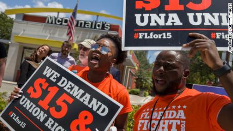 People gather to ask McDonald&#39;s to raise workers wages to a $15 minimum wage and demand the right to a union on May 23, 2019 in Fort Lauderdale, Florida.