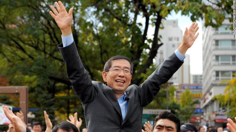 Park Won-Soon waves to supporters during a campaign rally in downtown Seoul on October 22, 2011.