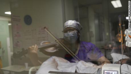 Chilean nurse Damaris Silva plays the violin for patients in Santiago, Chile.