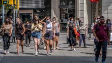 People wear face masks in Barcelona, Spain, where those who don&#39;t do so in a public space face a 100 euro fine.