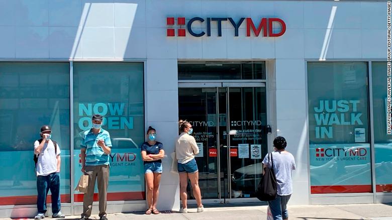 People form a line outside of the CityMD clinic in Forest Hills, Queens, New York.