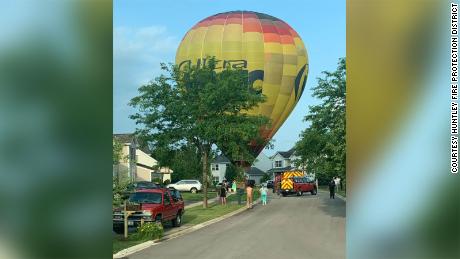 A hot air balloon made an emergency landing in an Illinois neighborhood after a passenger fainted