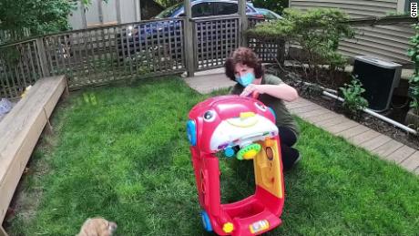 Daycare operator Cheryl Lekousi cleans a toy car she now only allows one child to climb into.