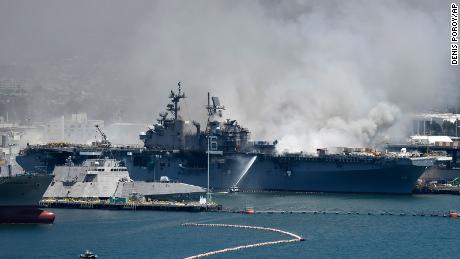 Federal firefighters continue to battle the blaze aboard the Navy ship.