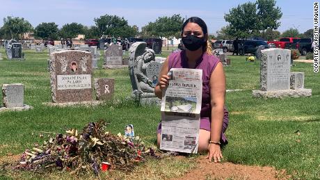 Kristin Urquiza hold her father&#39;s obituary over his grave.